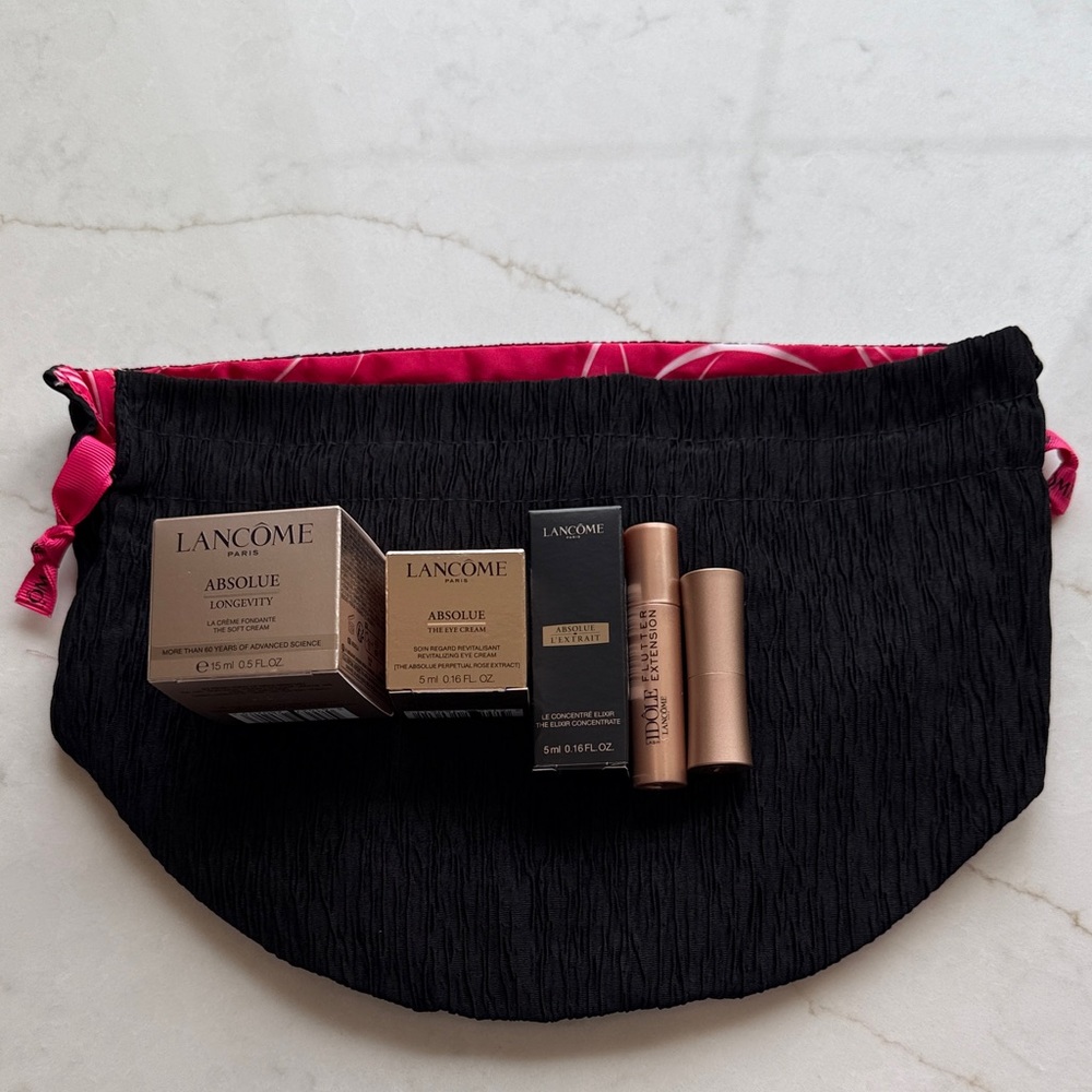Lancôme Absolue skincare set with black pouch and rose-gold accents